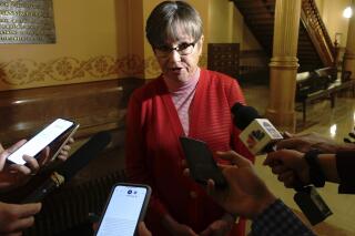 FILE - In this June 10, 2021 file photo, Kansas Gov. Laura Kelly speaks to reporters following an event at the Statehouse in Topeka, Kan. Kansas collected 9.3% more in taxes than it expected during its just-concluded 2021 budget year and Kelly touts it as a sign that efforts to rebuild the state's economy are working. (AP Photo/John Hanna, File)