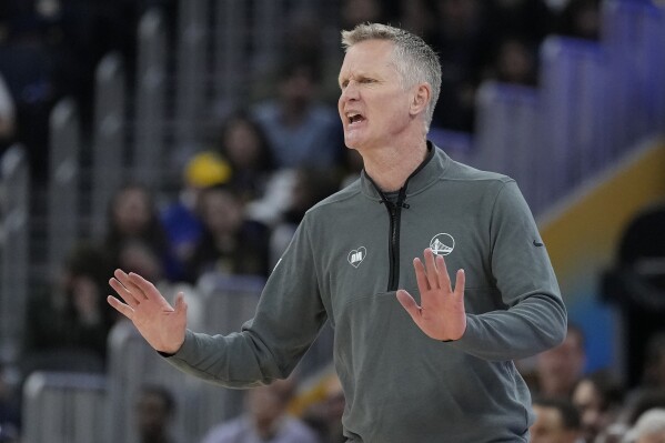Golden State Warriors head coach Steve Kerr gestures toward players during the first half of the team's NBA basketball game against the New York Knicks in San Francisco, Monday, March 18, 2024. (AP Photo/Jeff Chiu)