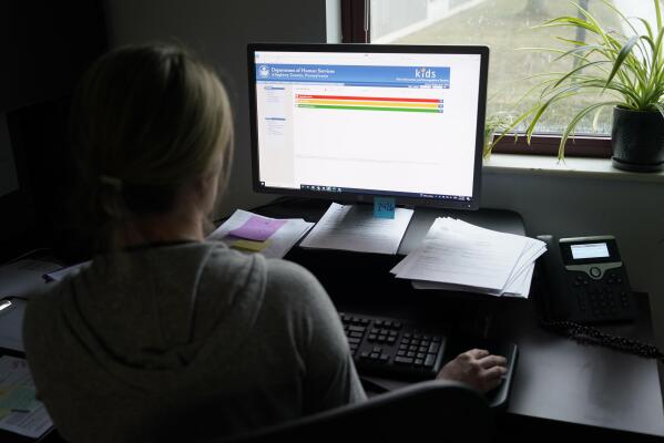 Case work supervisor Jessie Schemm looks over the first screen of software used by workers who field calls at an intake call screening center for the Allegheny County Children and Youth Services, in Penn Hills, Pa. Child welfare officials in the county say the cutting-edge algorithmic tool – which is capturing attention around the country – uses data to support agency workers as they try to protect children from neglect. The nuanced term can include everything from inadequate housing to poor hygiene. (AP Photo/Keith Srakocic)