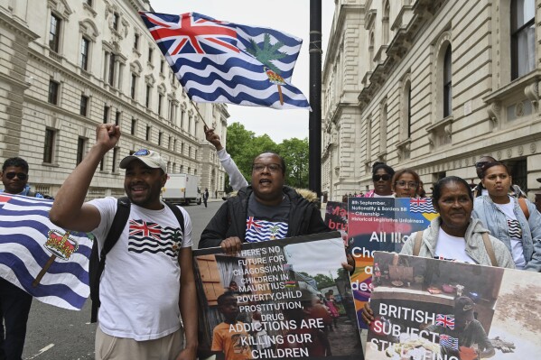People demonstrate outside the Foreign Office in London, Thursday, May 22, 2025, after a British court blocked the U.K. from transferring sovereignty over the Chagos Islands to Mauritius hours before the agreement was due to be signed. (AP Photo/Thomas Krych)