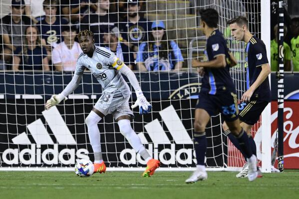 Philadelphia Union goalkeeper Andre Blake, left, watches the ball during the second half of the team's MLS soccer match against the Houston Dynamo, Saturday, July 30, 2022, in Chester, Pa. (AP Photo/Derik Hamilton)