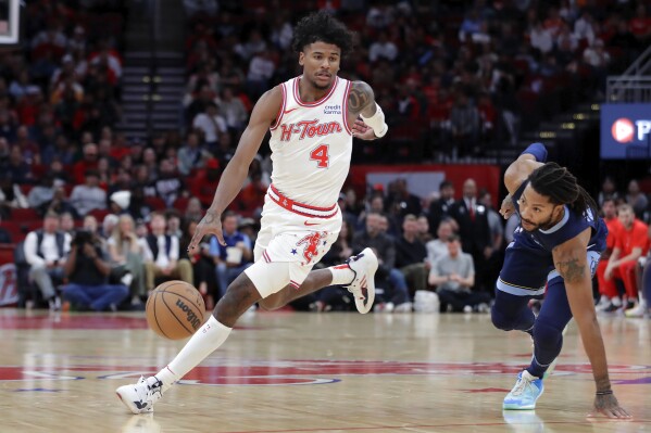 Houston Rockets guard Jalen Green (4) drives around Memphis Grizzlies guard Derrick Rose, right, as he loses his footing during the first half of an NBA basketball game, Wednesday, Nov. 22, 2023, in Houston. (AP Photo/Michael Wyke)