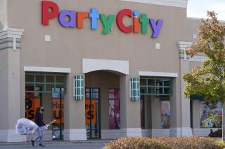 FILE A shopper leaves a Party City store in Vernon Hills, Ill., Thursday, Oct. 15, 2020. Party City Holdco Inc. has filed for Chapter 11 bankruptcy protection, Wednesday, Jan. 18, 2023 as the party supply chain confronts inflationary pressures and a pullback in consumer spending. The party supplies chain, which operates more than 800 company-owned and franchise stores throughout North America, has been long struggling with increased competition from the likes of Walmart and Target. (AP Photo/Nam Y. Huh, File)