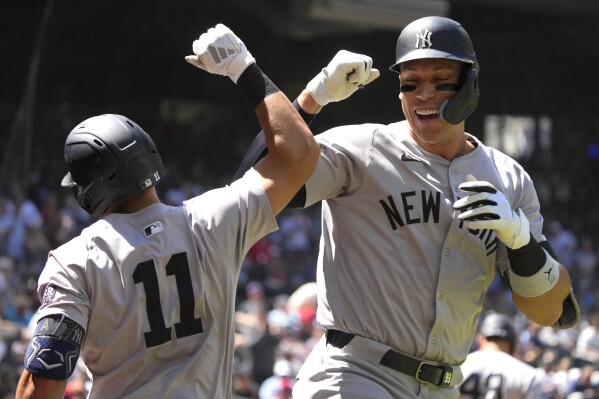 New York Yankees' Aaron Judge celebrates with Anthony Volpe (11) after hitting a two run home run against the Arizona Diamondbacks in the first inning during a baseball game, Wednesday, April 3, 2024, in Phoenix. (AP Photo/Rick Scuteri)