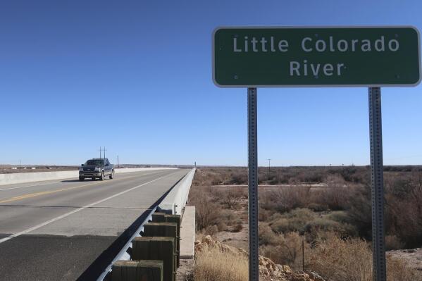 A vehicle crosses a bridge on Interstate 40 that goes over the Little Colorado River in Winslow, Arizona, on Feb. 4, 2022. The U.S. Army Corps of Engineers recently announced a flood control project in the city would receive $65 million in funding. (AP Photo/Felicia Fonseca)