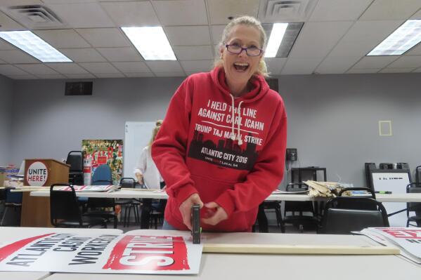 Ruth Ann Joyce, a bartender at the Harrah's and Hard Rock casinos in Atlantic City, N.J. assembles "On Strike" signs at the Atlantic City headquarters of Local 54 of the Unite Here union on Tuesday, June 28, 2022. (AP Photo/Wayne Parry)