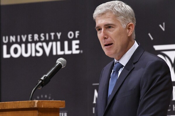 FILE - Supreme Court Justice Neil Gorsuch speaks to an audience as a guest of Sen. Mitch McConnell, R-Ky., at the University of Louisville, Sept. 21, 2017, in Louisville, Ky. Records obtained by The Associated Press show that Supreme Court justices have attended publicly funded events at colleges and universities that allowed the schools to put the justices in the room with influential donors, including some whose industries have had interests before the court. (AP Photo/Timothy D. Easley, File)