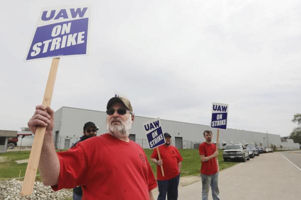 FILE - Members of United Auto Workers Local 807 picket after going on strike, May 2, 2022, at a CNH plant in Burlington, Iowa. More than 1,000 striking CNH Industrial workers in Iowa and Wisconsin will soon vote on an offer from the maker of construction and agricultural equipment for the first time since they walked off the job eight months ago. The UAW union said it would schedule a vote on the company’s latest upgraded offer but it did not release any details of what is included in the offer. (John Loveretta/The Hawk Eye via AP, File)