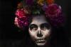 A woman dressed as Mexico's iconic "Catrina" poses for tourists in Mexico City's main square, the Zocalo, as part of the Day of the Dead festivities in Mexico City, Friday, Oct. 28, 2022. The holiday honors the dead as friends and family gather in cemeteries to decorate the graves of their loved ones. and hold a vigil during the night of November 1 and 2. (AP Photo/Marco Ugarte)