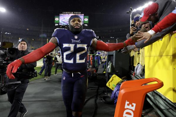 Tennessee Titans running back Derrick Henry (22) celebrates with fans after the team's NFL football game against the Green Bay Packers Thursday, Nov. 17, 2022, in Green Bay, Wis. (AP Photo/Matt Ludtke)