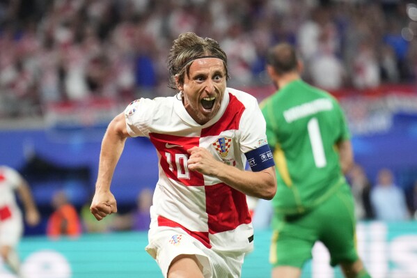  Croatia's Luka Modric celebrates after scoring his side's opening goal during a Group B match between Croatia and Italy at the Euro 2024 soccer tournament in Leipzig, Germany, Monday, June 24, 2024. (AP Photo/Ebrahim Noroozi)