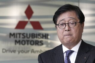 FILE - In this Jan. 18, 2019, file photo, Mitsubishi Motors CEO Osamu Masuko bites his lips during a press conference at its headquarters in Tokyo. Mitsubishi Motors Corp. Special Adviser Osamu Masuko, who engineered the alliance with Nissan, has died, the Japanese automaker said Monday, Aug. 31, 2020. He was 71. (AP Photo/Eugene Hoshiko, File)