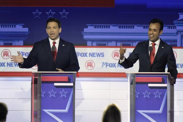 Florida Gov. Ron DeSantis and businessman Vivek Ramaswamy speak at the same time during a Republican presidential primary debate hosted by FOX News Channel Wednesday, Aug. 23, 2023, in Milwaukee. (AP Photo/Morry Gash)