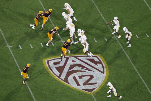 FILE - The Pac-12 logo is shown during the second half of an NCAA college football game between Arizona State and Kent State, in Tempe, Ariz., Aug. 29, 2019. Southeastern Conference and Pac-12 officials are expected to provide the final approval of a $2.8 billion plan that will settle antitrust claims and set the stage for college athletes to start sharing the billions of dollars flowing to their schools. (AP Photo/Ralph Freso, File)