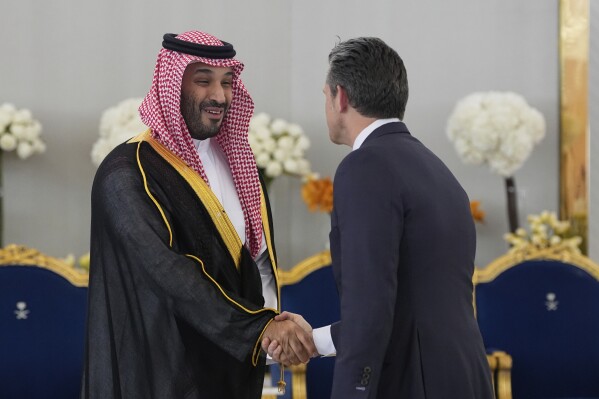 Saudi Crown Prince Mohammed bin Salman shakes hands with Defense Secretary Pete Hegseth during a coffee ceremony for President Donald Trump at the Royal Terminal of King Khalid International Airport in Riyadh, Saudi Arabia, Tuesday, May 13, 2025 (AP Photo/Alex Brandon)