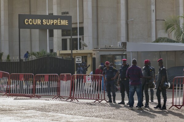 Senegal police stands in front of the Supreme Court in Dakar, Senegal, Friday, Nov. 17, 2023, as the court is due to rule on whether opposition leader and presidential hopeful Ousmane Sonko can take part in the upcoming February election despite being struck from the country's voter rolls after his conviction on charges of corrupting youth earlier this year. (AP Photo/Sylvain Cherkaoui)