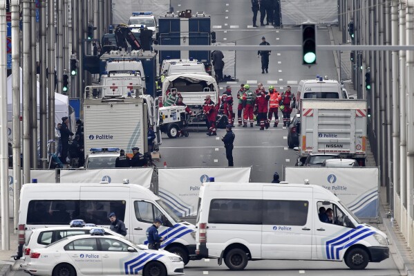 FILE - Police and rescue teams are pictured outside the metro station Maelbeek after an incident, in Brussels, Tuesday, March 22, 2016. A jury is expected to render its verdict Tuesday, July 25, 2023 over Belgium’s deadliest peacetime attack. The suicide bombings at the Brussels airport and a busy subway station in 2016 killed 32 people in a wave of violence in Europe claimed by the Islamic State group. Among the 10 defendants is Salah Abdeslam, serving a life sentence in France over his role in 2015 Paris attacks. (AP Photo/Martin Meissner, File)