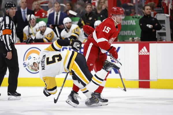 Detroit Red Wings left wing Jakub Vrana (15) and Pittsburgh Penguins defenseman Mike Matheson (5) collide during the first period of an NHL hockey game, Saturday, April 23, 2022, in Detroit. (AP Photo/Al Goldis)
