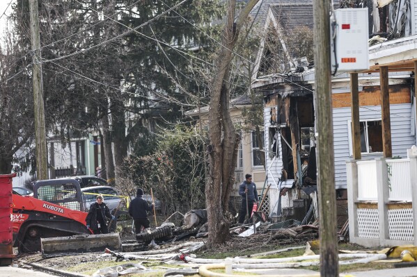 Investigators work at the scene where two police officers were injured while responding to reported standoff in East Lansdowne, Pa., Thursday, Feb. 8, 2024. (Heather Khalifa/The Philadelphia Inquirer via AP)