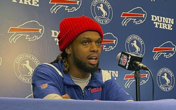 Buffalo Bills safety Damar Hamlin speaks to reporters at the NFL football team's facility in Orchard Park, N.Y., Tuesday, April 18, 2023, saying he plans to resume his football career after being cleared to play more than four months after going into cardiac arrest and needing to be resuscitated on the field during a game at Cincinnati. (AP Photo/John Wawrow)