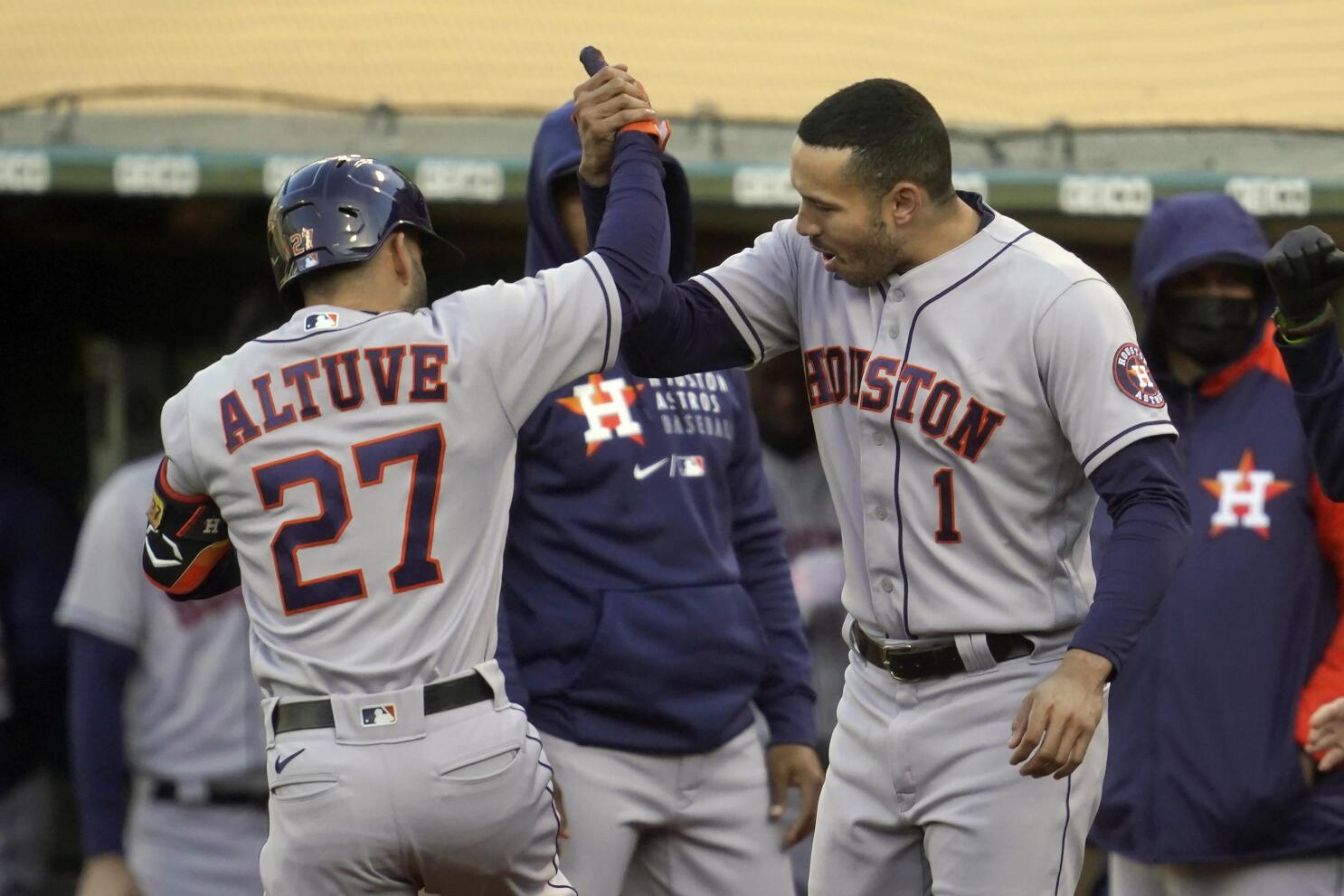 Jose Altuve of the Houston Astros high fives Gary Pettis hitting a