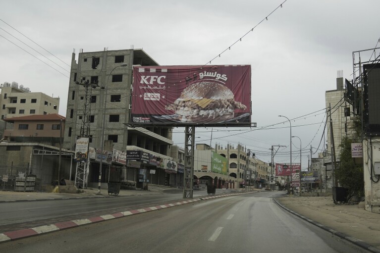 The flashpoint Palestinian town of Hawara, once a bustling hub of commerce along the West Bank's main highway, is seen as deserted after the Israeli military closed shops and banned Palestinian vehicles from the main road in the wake of Palestinian militant attacks and settler violence in the town, Sunday, Nov. 12, 2023. With the world’s attention focused on the fighting in Gaza, Israeli settler violence against Palestinians since Oct. 7 has surged to the highest levels ever recorded by the United Nations. Palestinians say this Israel-Hamas war has left them more scared and vulnerable than ever in recent memory. (AP Photo/Mahmoud Illean)