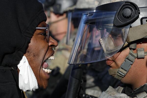 Protesters and National Guardsmen face off on East Lake Street, Friday, May 29, 2020, in St. Paul...