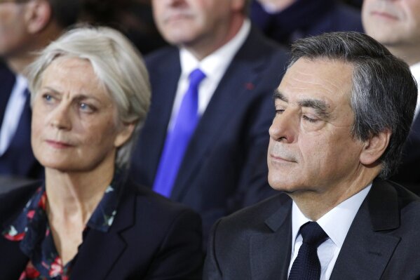 
              FILE - In this Jan. 29, 2017 file photo, conservative presidential candidate Francois Fillon and his wife Penelope attend a campaign meeting in Paris. A French judicial official says investigating judges have requested that former Prime Minister Francois Fillon and his wife stand trial on corruption charges. (AP Photo/Christophe Ena, File)
            