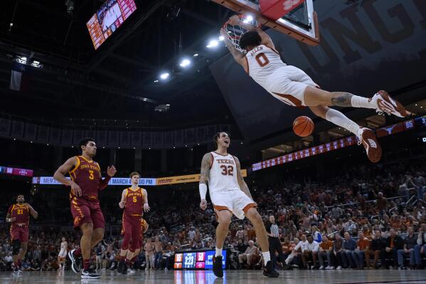 Texas forward Christian Bishop (32) celebrates as teammate Timmy Allen (0) scores against Iowa State during the second half of an NCAA college basketball game in Austin, Texas, Tuesday, Feb. 21, 2023. (AP Photo/Eric Gay)