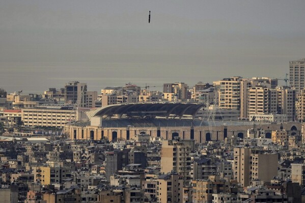 A bomb dropped from an Israeli jet falls before hitting a building in Dahiyeh, in the southern suburb of Beirut, Lebanon, Friday, March 28, 2025. (AP Photo/Hassan Ammar)