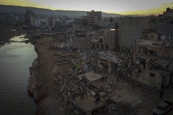 FILE - People search for flood victims in Derna, Libya, Friday, Sept. 15, 2023. Earth last year shattered global annual heat records, the European climate agency said Tuesday, Jan. 9, 2024. (AP Photo/Ricardo Garcia Vilanova, File)