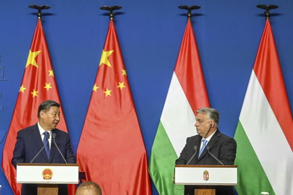 FILE - Chinese President Xi Jinping, left, speaks during his joint press conference with Hungarian Prime Minister Viktor Orban following their talks at the PM's office, the former Carmelite Monastery, in Budapest, Hungary, Thursday, May 9 2024. Most countries in the European Union are making efforts to “de-risk” their economies from perceived threats posed by China. But Hungary and Serbia have gone in the other direction. They are courting major Chinese investments in the belief that the world’s second-largest economy is essential for Europe’s future. (Szilard Koszticsak/MTI via AP)