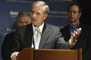 FILE - In this July 17, 2004, file photo, former GOP National Campaign Chairman Marc Racicot speaks at a news conference for a Bush-Cheney campaign event in Seattle. The former Montana governor and Republican National Committee chair said on Tuesday, Sept. 29, 2020, he will vote for Democrat Joe Biden in the November election, citing character flaws in President Donald Trump. Racicot, 72, served two terms as governor after being elected in 1992 and again 1996, and was RNC chairman in 2002 and 2003. (AP Photo/Jim Bryant, File)