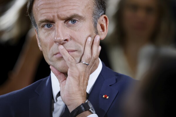 French President Emmanuel Macron listens to teachers during a visit to a vocational school in Orange, Southeastern France, Friday Sept. 1, 2023. (Ludovic Marin/Pool Photo via AP)