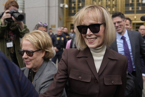 FILE — E. Jean Carroll, right, walks out of Manhattan federal court, May 9, 2023, in New York. Lawyers for former President Donald Trump say he may testify at a mid-January trial set to decide how much he owes Carroll for defaming her after she said he sexually abused her three decades ago in a Manhattan department store. The lawyers filed papers in Manhattan federal court late Thursday, Dec. 29, 2023, to request that Trump's October 2022 deposition transcript in the case not be shown to the jury because Trump has been named as a witness likely to testify at the trial. (AP Photo/Seth Wenig, File)