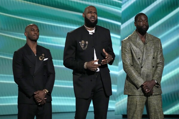 Chris Paul, from left, LeBron James, and Dwyane Wade do a tribute to Carmelo Anthony at the ESPY awards on Wednesday, July 12, 2023, at the Dolby Theatre in Los Angeles. (AP Photo/Mark J. Terrill)