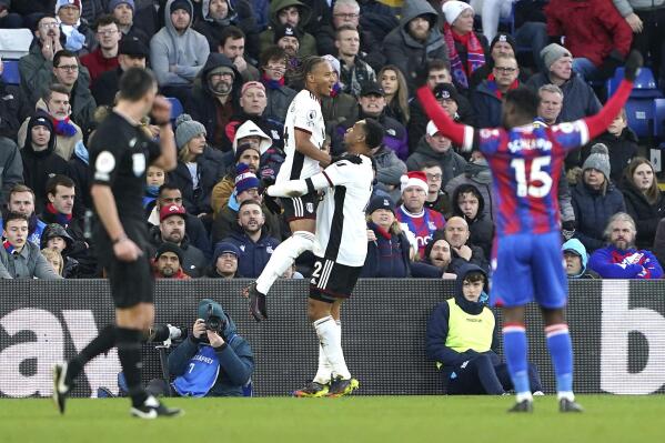 Fulham's Bobby Decordova-Reid, centre left celebrates scoring their side's first goal of the game during the English Premier League soccer match between Crystal Palace and Fulham, at Selhurst Park, London, Monday, Dec. 26, 2022. (Zac Goodwin/PA via AP)