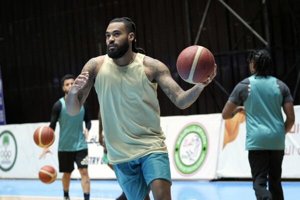 Isaac Banks, an American basketball player with the Hashed al-Shaabi - the Popular Mobilization Forces - in the Iraqi Basketball Super League, takes part in a team practice in Baghdad, Iraq, Thursday, March 21, 2024. U.S. players are in high demand on Iraqi basketball teams, even those whose owners have a tense relationship with Washington. (AP Photo/Hadi Mizban)