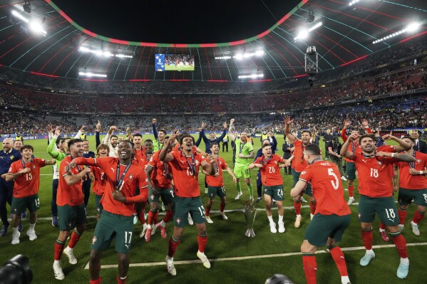 Portugal's players celebrate with the trophy after winning the Nations League soccer championship at the Allianz Arena in Munich, Germany, Sunday, June 8, 2025. (AP Photo/Martin Meissner)