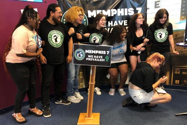 A group of fired Starbucks employees celebrate the result of a vote to unionize one of the coffee company's locations on Tuesday, June 7, 2022, in Memphis, Tenn. The so-called "Memphis Seven" jumped for joy, hugged each other and wept after a count held by the National Labor Relations Board showed an 11-3 vote in favor of unionization of a Starbucks in Memphis. Starbucks said they were fired for violating company policies, but the seven say they were let go in retaliation for unionization efforts. (AP Photo/Adrian Sainz)