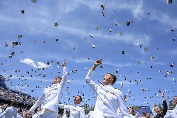 Members of the Naval Academy's class of 2023 toss their caps in the air at the conclusion of the U.S. Naval Academy's graduation and commissioning ceremony at the Navy-Marine Corps Memorial Stadium on Friday, May 26, 2023 in Annapolis, Md. (Jerry Jackson /The Baltimore Sun via AP)