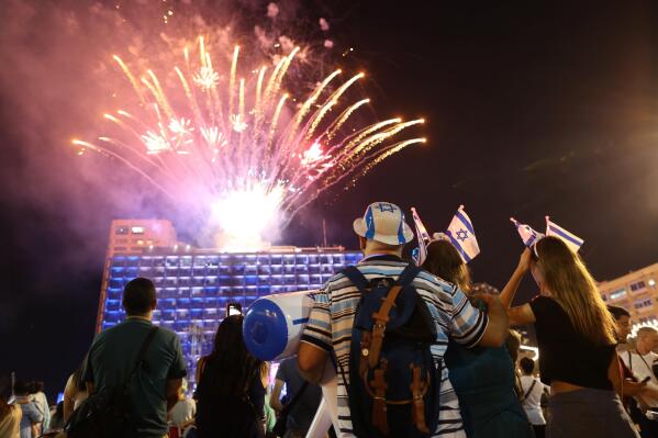 FILE - Israelis watch a fireworks display during the celebrations for Israel's 70th Independence Day, at Rabin square in Tel Aviv, Israel, Wednesday, April 18, 2018. Although fireworks are a typical mainstay at Independence Day parties across the country, 2022's noisy celebrations have been cancelled over concerns by some military veterans who say the cracking and banging dredges up the horrors of battle. (AP Photo/Oded Balilty, File)