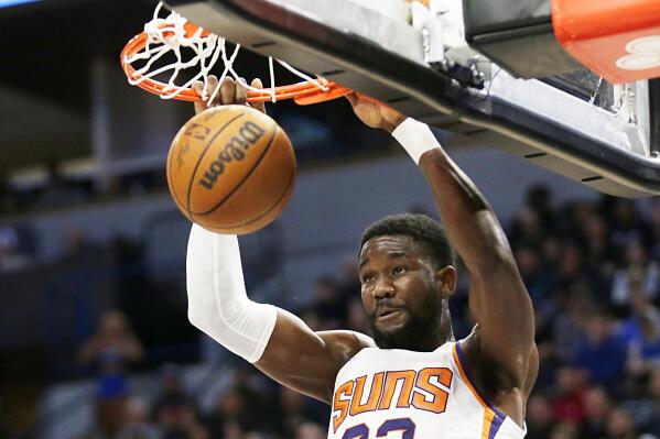 Phoenix Suns center Deandre Ayton dunks against the Minnesota Timberwolves during the second half of an NBA basketball game Wednesday, March 23, 2022, in Minneapolis. (AP Photo/Andy Clayton-King)