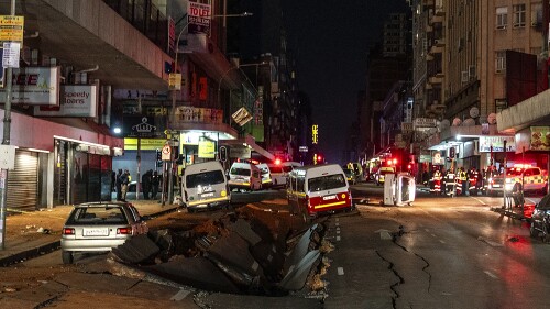 Emergency services gather at the scene of a gas explosion downtown Johannesburg, South Africa, Wednesday July 19, 2023. Search and rescue officials also ordered residents in nearby buildings to evacuate the area and the area where the explosion happened was cordoned off. (AP Photo/ Shiraaz Mohamed)