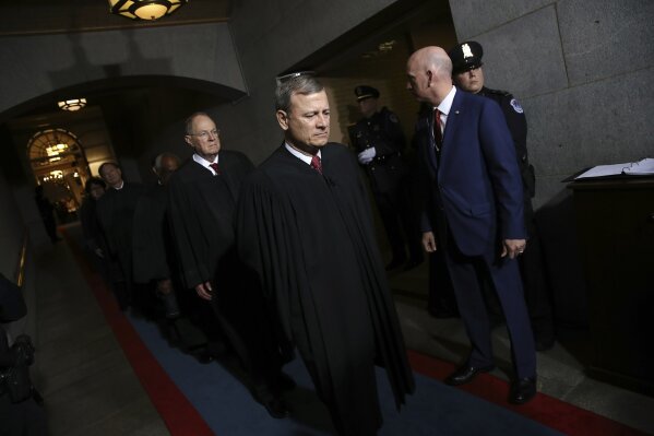 FILE - In this Jan. 20, 2017, file photo Supreme Court Chief Justice John Roberts, right, and Justice Anthony Kennedy arrive on the West Front of the U.S. Capitol in Washington, for Donald Trump's inauguration ceremony as the 45th president of the United States. (Win McNamee/Pool Photo via AP, File)