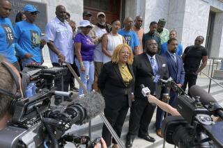 FILE - Attorneys and backers of an effort to make a ban on non-unanimous jury verdicts retroactive in New Orleans gather on the steps of the state Supreme Court building, Tuesday, May 10, 2022, after the court heard arguments.  Prohibitions against non-unanimous jury convictions — outlawed by Louisiana voters in 2018 and, later, by the U.S. Supreme Court — do not have to apply retroactively to earlier convictions, Louisiana's highest court ruled Friday, Oct. 21, 2022. (AP Photo/Kevin McGill, File)