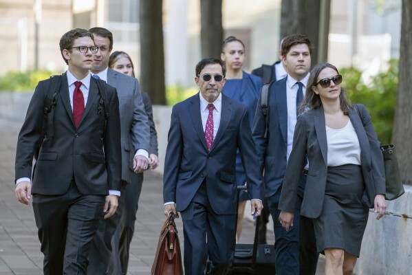 U.S. Department of Justice lawyers, including Kenneth Dintzer, center, and Megan Bellshaw, right, arrive at the E. Barrett Prettyman U.S. Federal Courthouse, Tuesday, Sept. 12, 2023 in Washington. Google will confront a threat to its dominant search engine beginning Tuesday when federal regulators launch an attempt to dismantle its internet empire in the biggest U.S. antitrust trial in a quarter century. (AP Photo/Nathan Howard)