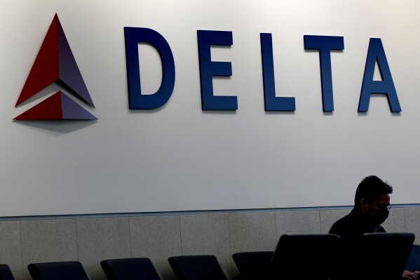 FILE - A man waits for a Delta Air Lines flight at Hartsfield-Jackson International Airport in Atlanta, Jan. 7, 2022. An emergency slide fell off a Delta plane that was taking off from New York's John F. Kennedy International Airport, Friday, April 26, 2024. The pilots returned to the airport and landed safely. (AP Photo/Charlie Riedel, File)