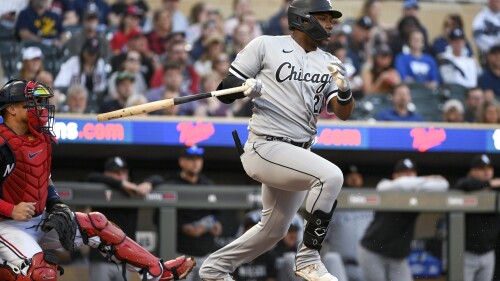 FILE - Chicago White Sox' Oscar Colas follows through after making contact, during the first inning of the team's baseball game against the Minnesota Twins on April 11, 2023, in Minneapolis. The White Sox recalled Colás from Triple-A Charlotte on Tuesday, July 4, confident the Cuban outfielder will perform better than he did at the start of the season. (AP Photo/Craig Lassig, File)