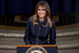 First lady Melania Trump smiles during a speech at the Justice Department's National Opioid Summit at the Department of Justice, Friday, March 6, 2020, in Washington. (AP Photo/Andrew Harnik)
